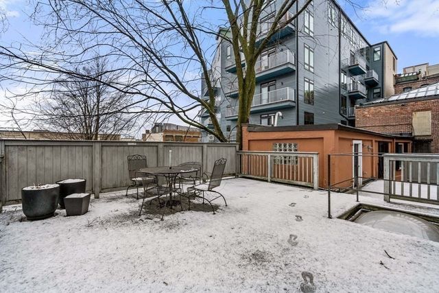 a backyard of a house with table and chairs
