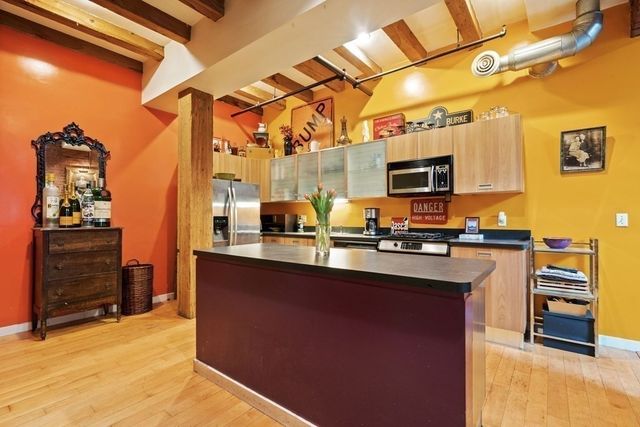 a kitchen with stainless steel appliances a sink stove and refrigerator