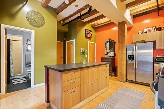 a kitchen with stainless steel appliances granite countertop a refrigerator and a sink