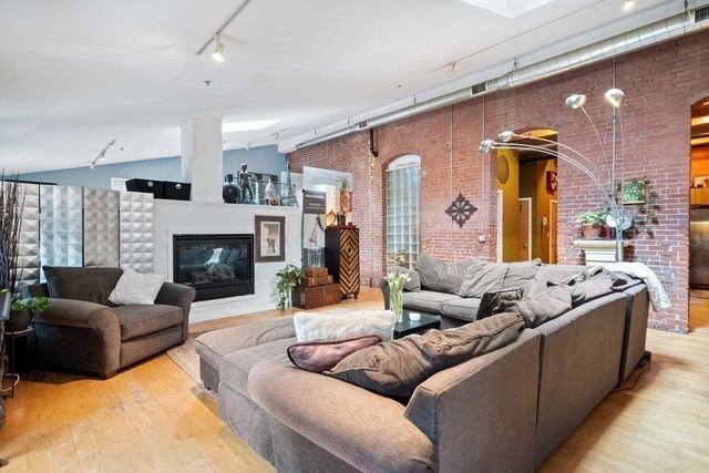 a living room with furniture window and a fireplace