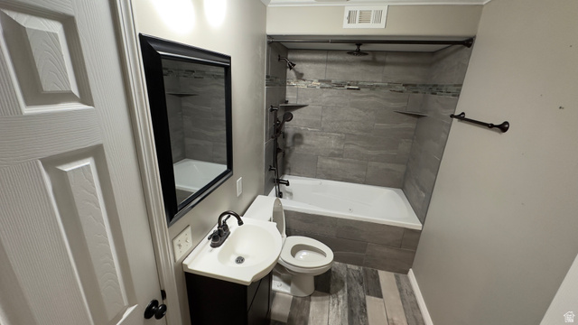 3547 East Golden Eagle Road Eagle Mountain, UT 84005 - Photo 30 of 47 Bathroom featuring dark wood-style flooring, vanity, and a combined bath / shower with rainfall shower
