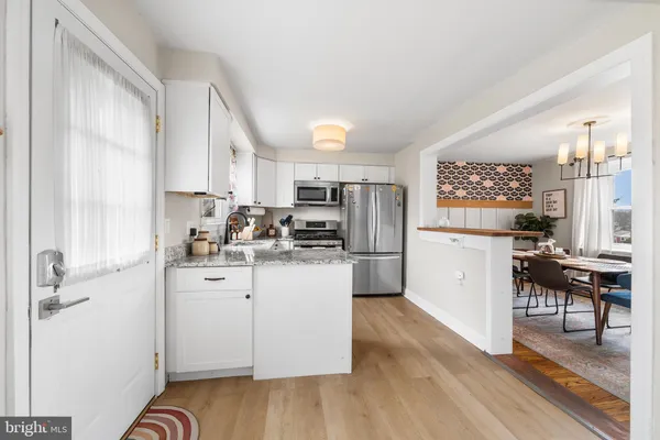 a kitchen with stainless steel appliances a refrigerator and a stove top oven