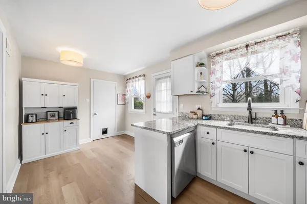 a kitchen with granite countertop a sink and cabinets