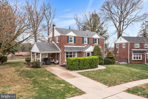 front view of a brick house with a yard