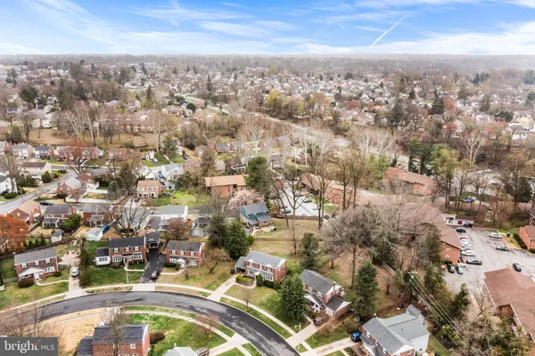 an aerial view of residential houses with city view
