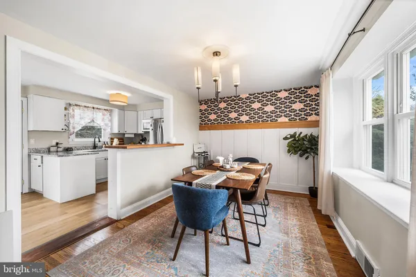 a dining room with furniture and wooden floor
