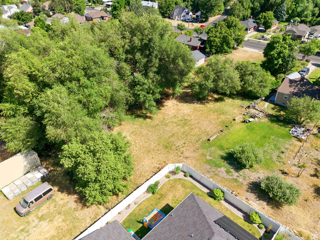 300 East S, Unit 2 Logan, UT 84321 - Photo 8 of 38 Expansive property lot featuring both grassy and treed areas, offering a varied natural landscape