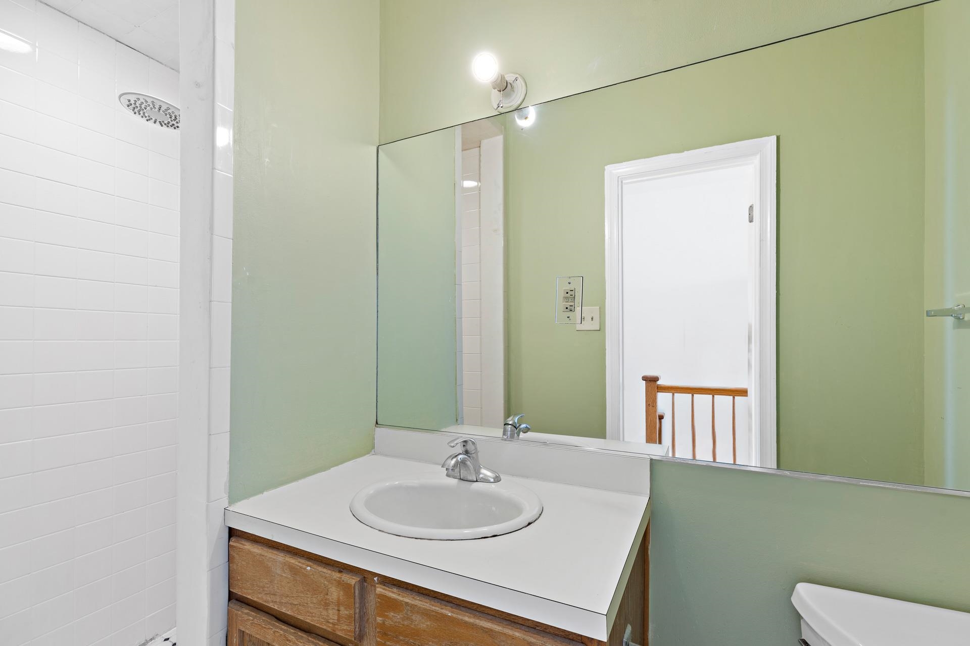 82 Jackson Street, Unit B5 Hoboken, NJ 07030 - Photo 11 of 14 a bathroom with a sink and a mirror