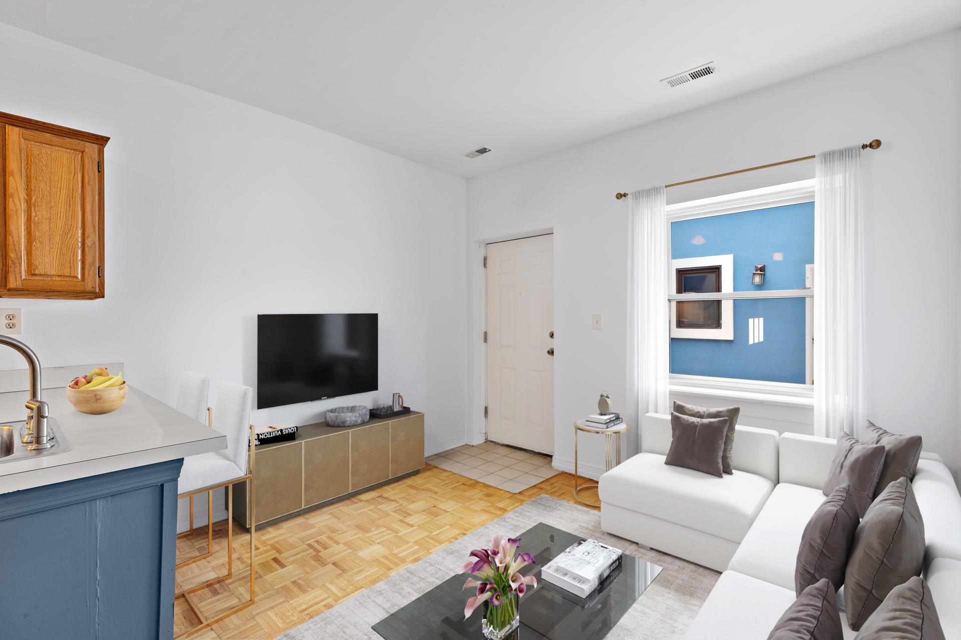 82 Jackson Street, Unit B5 Hoboken, NJ 07030 - Photo 3 of 14 a living room with furniture and a flat screen tv