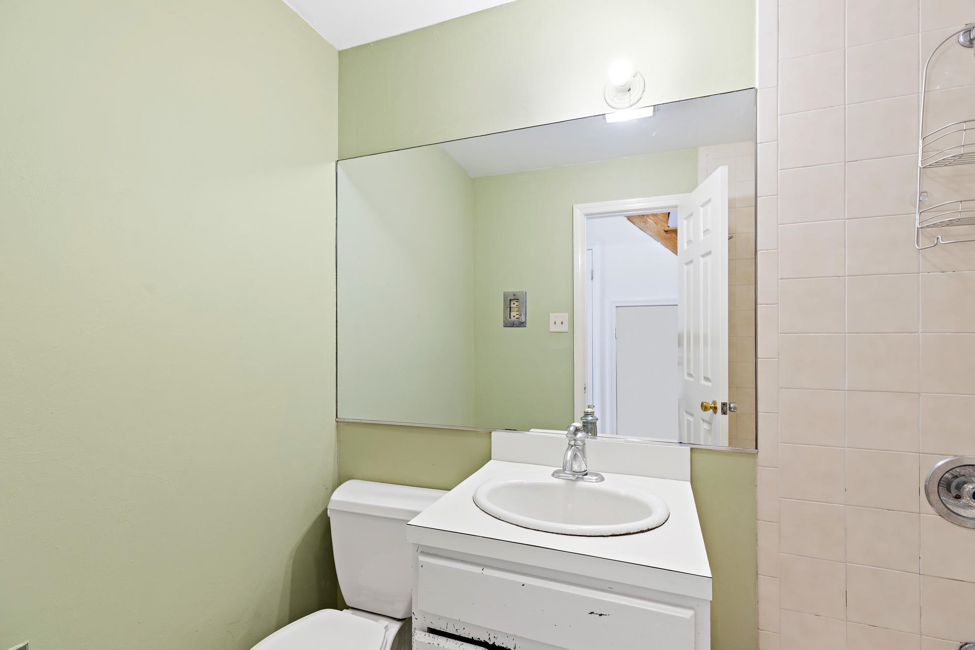 82 Jackson Street, Unit B5 Hoboken, NJ 07030 - Photo 6 of 14 a bathroom with a sink mirror vanity and toilet