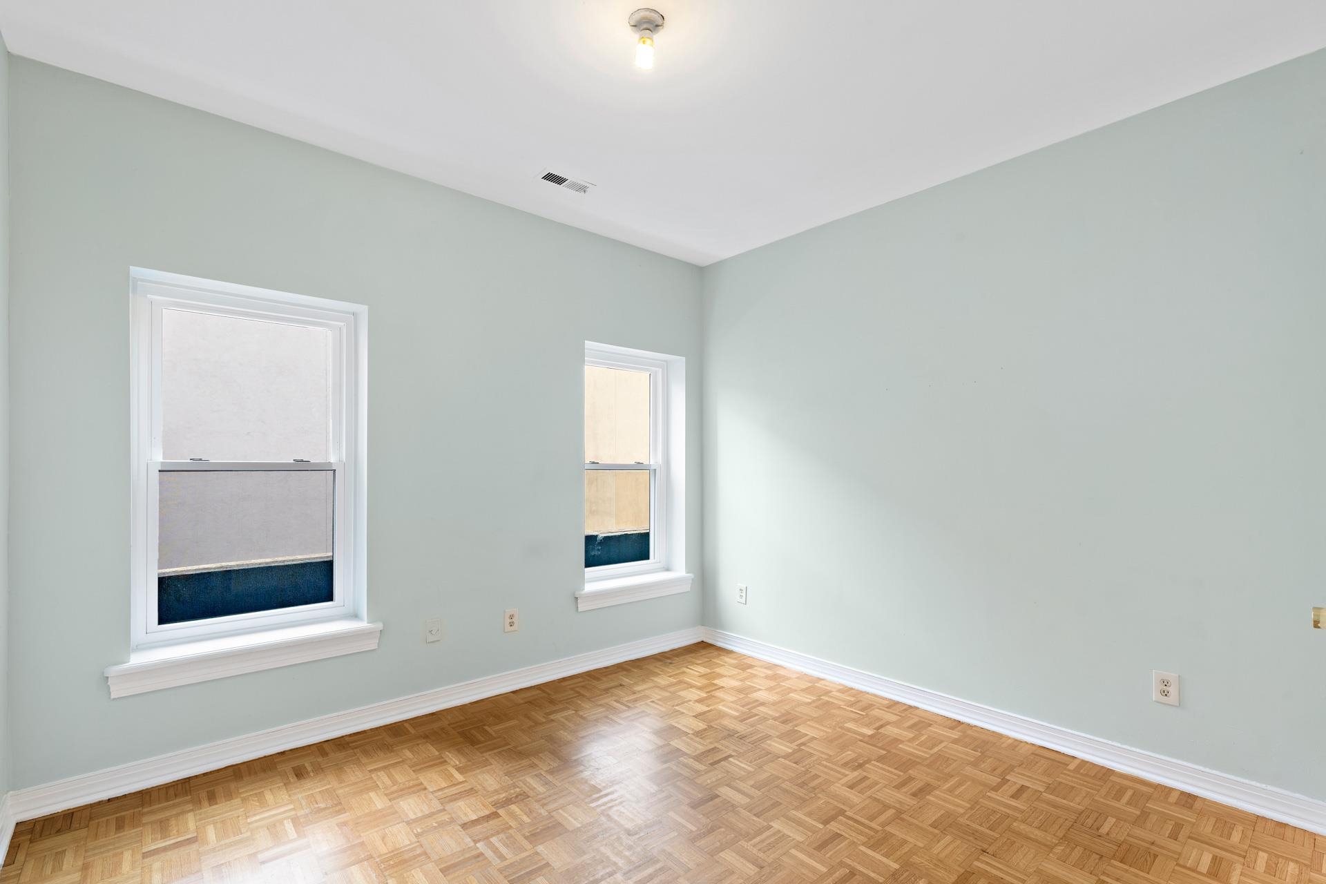 82 Jackson Street, Unit B5 Hoboken, NJ 07030 - Photo 7 of 14 an empty room with windows