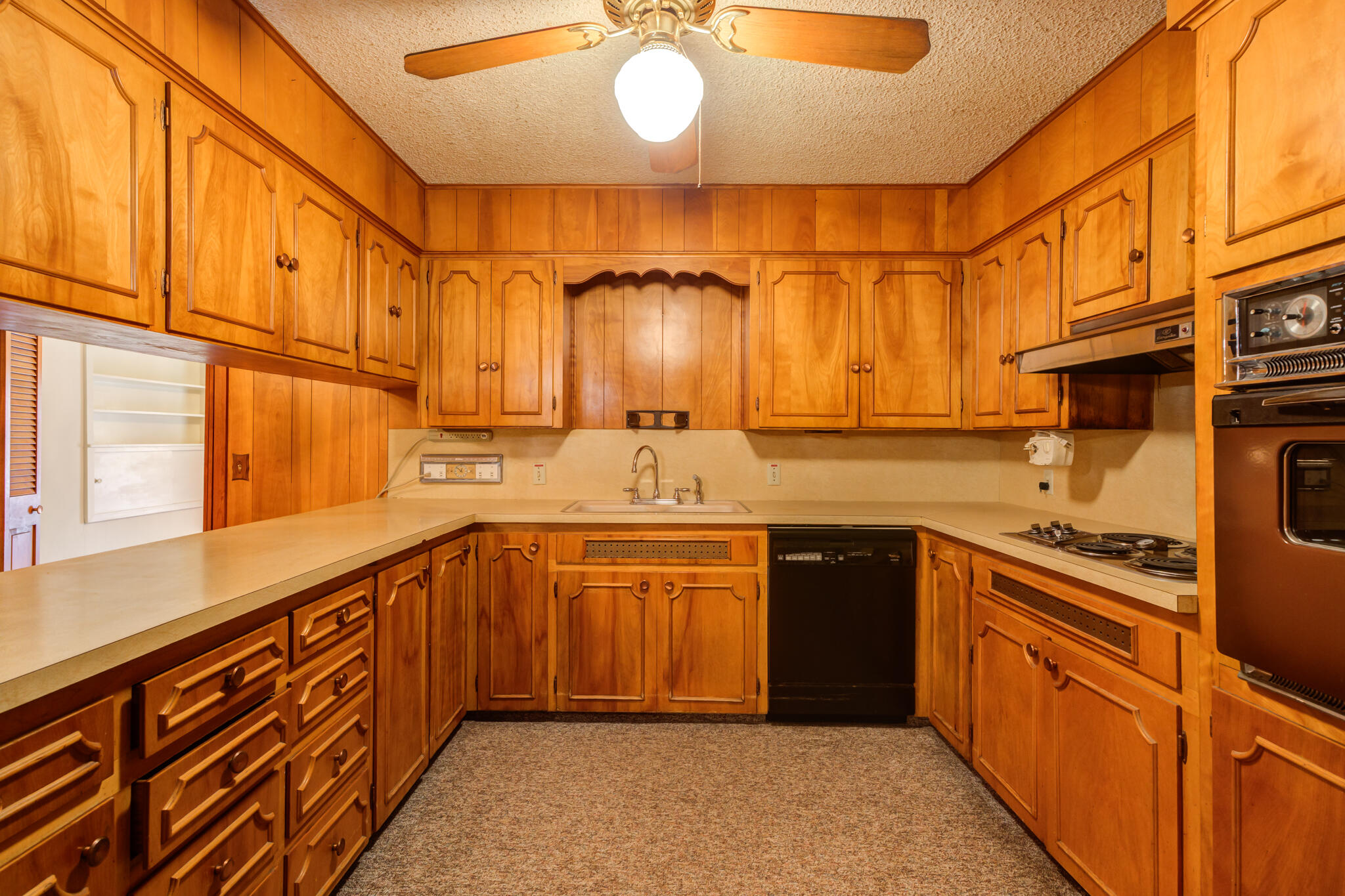 111 East 13th Street Littlefield, TX 79339 - Photo 12 of 38 a kitchen with stainless steel appliances granite countertop a sink and cabinets