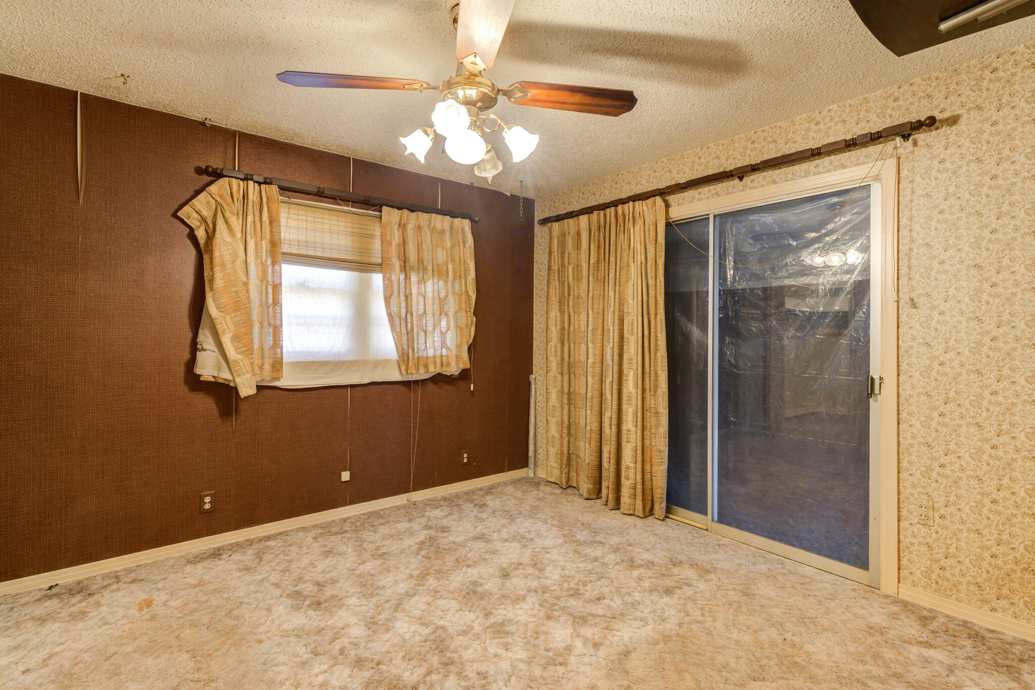 111 East 13th Street Littlefield, TX 79339 - Photo 19 of 38 a view of a livingroom with a chandelier fan and a window