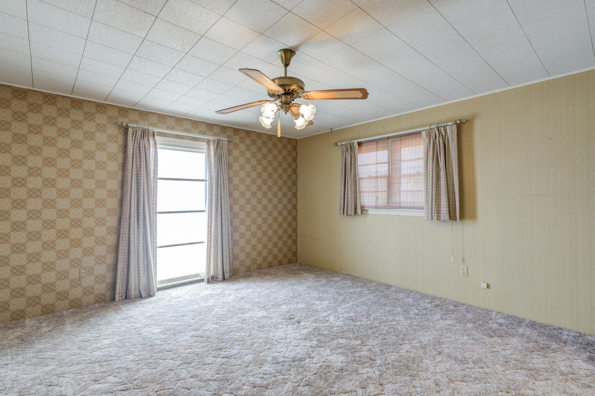 111 East 13th Street Littlefield, TX 79339 - Photo 24 of 38 an empty room with windows and fan