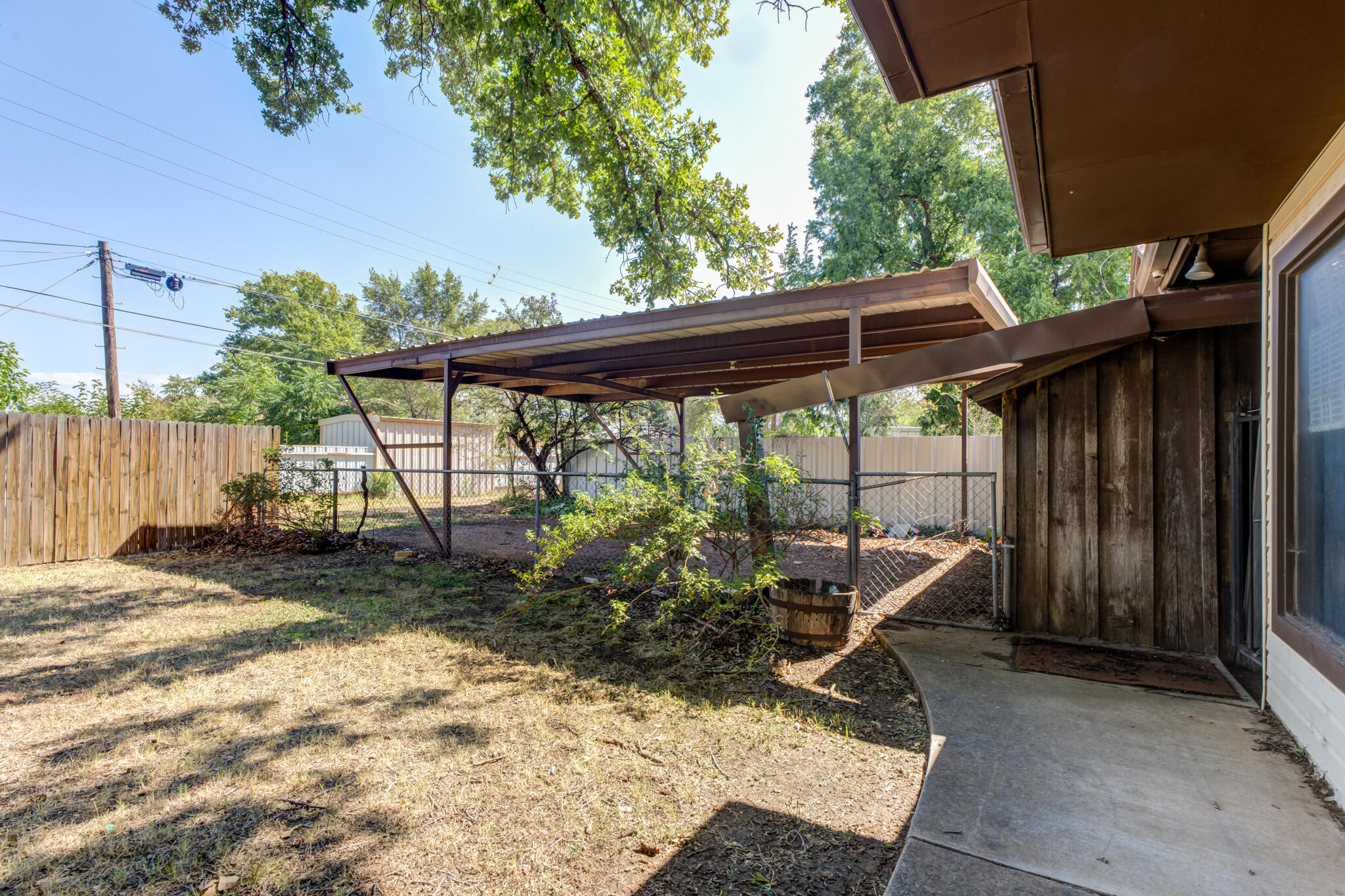 111 East 13th Street Littlefield, TX 79339 - Photo 35 of 38 a view of backyard with seating space and wooden fence