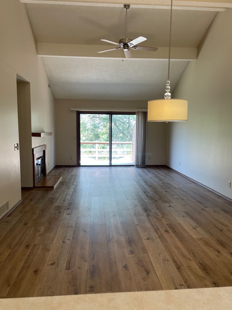 2148 Sunview Drive, Unit 2148 Champaign, IL 61821 - Photo 2 of 8 wooden floor in an empty room with a window