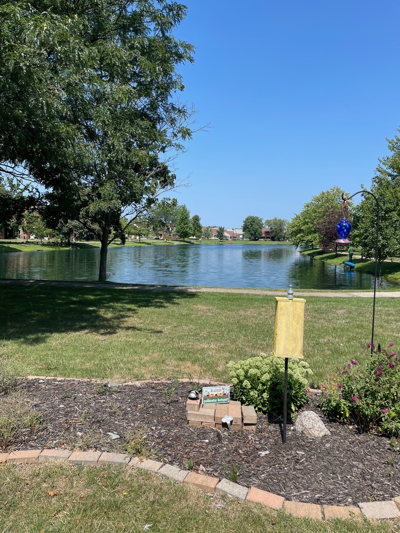 2148 Sunview Drive, Unit 2148 Champaign, IL 61821 - Photo 8 of 8 a view of a lake with a big yard