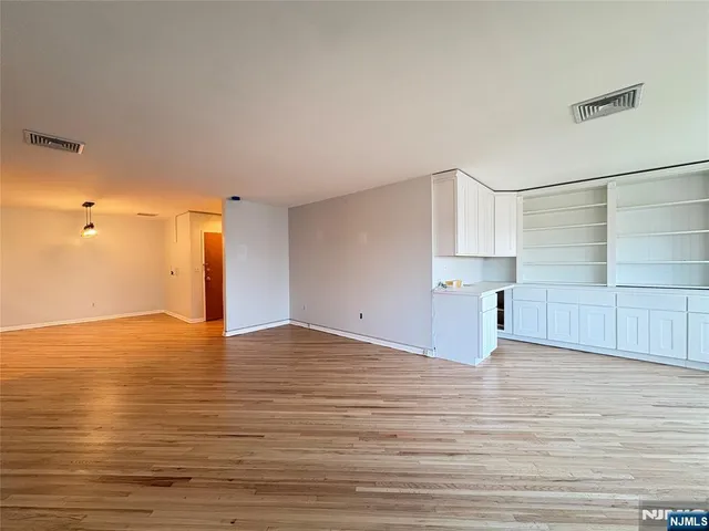 a kitchen with granite countertop a stove a sink and a window