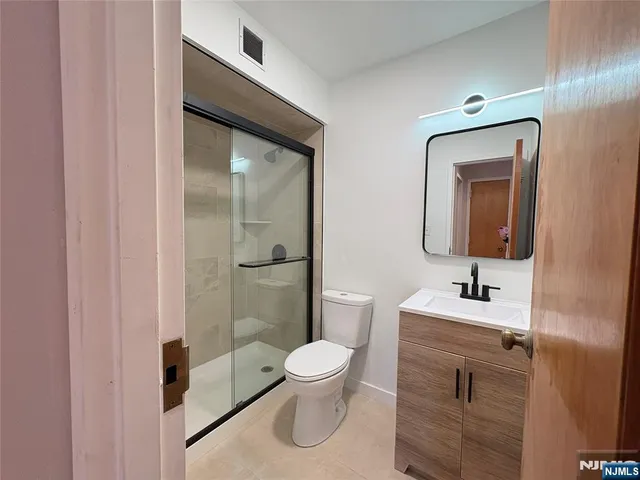 a view of a room with wooden floor and windows
