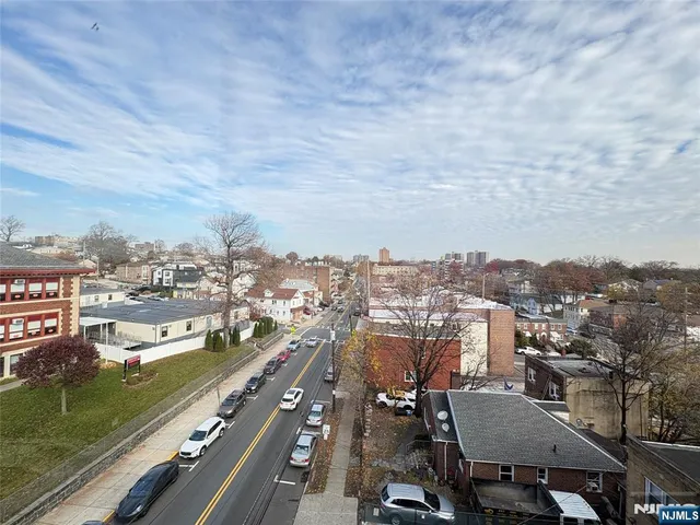 a view of hallway with wooden floor