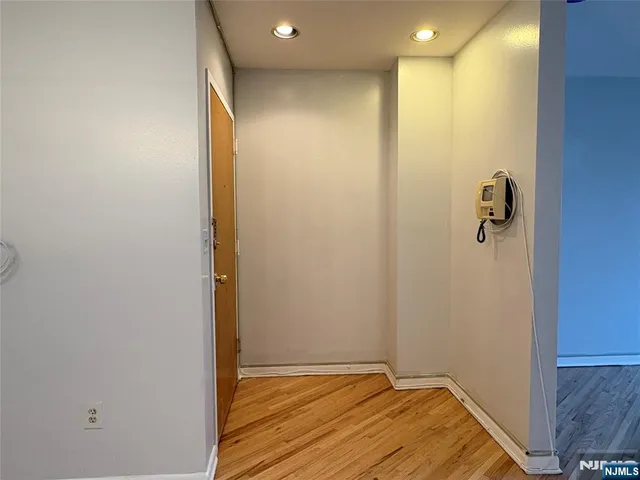 a big room with wooden floor and windows