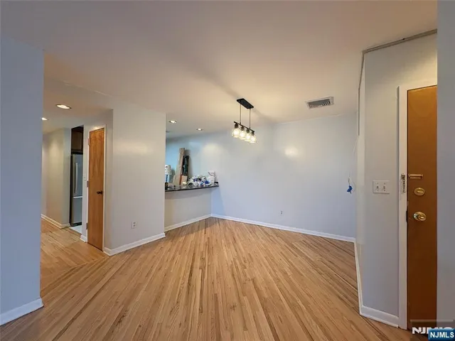 a view of wooden floor and windows in an empty room