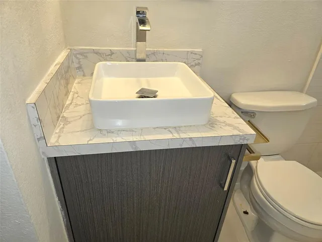 a bathroom with a shower a toilet and a window