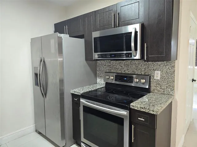 a kitchen with a stove microwave and refrigerator