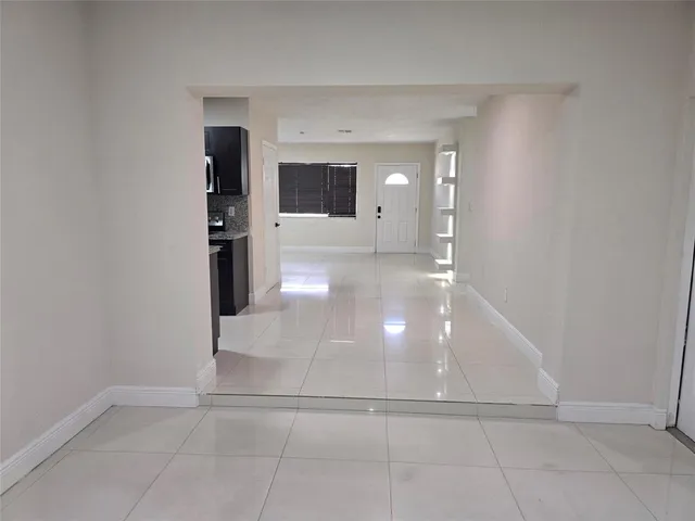 an empty room with closet and mirrors