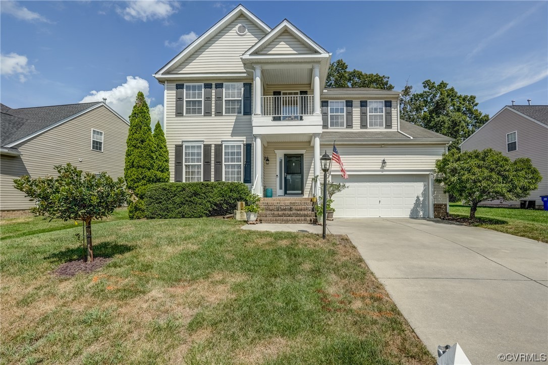 2407 Cascade Meadows Drive Midlothian, VA 23112 - Photo 2 of 48 a front view of a house with a yard and garage