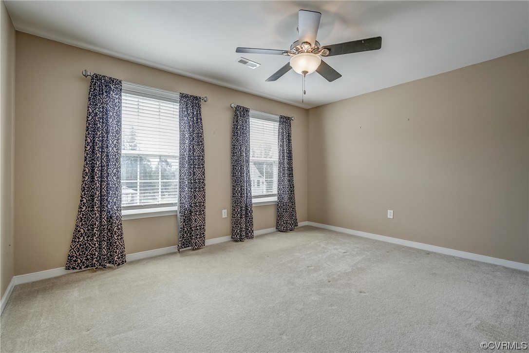 2407 Cascade Meadows Drive Midlothian, VA 23112 - Photo 40 of 48 an empty room with chandelier fan and windows