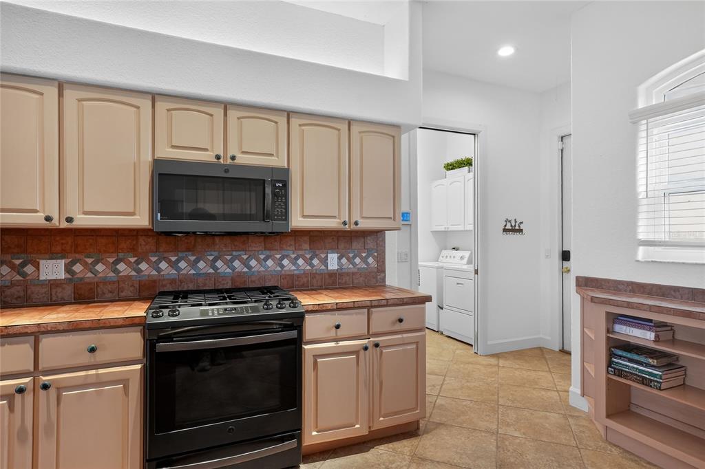 2968 Plantation Road Winter Haven, FL 33884 - Photo 22 of 81 a kitchen with cabinets stainless steel appliances and a window