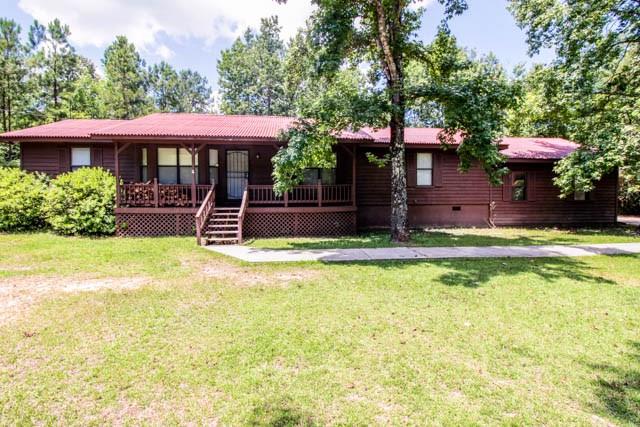 4 Broyles Road Phenix City, AL 36869 - Photo 1 of 15 a front view of a house with swimming pool