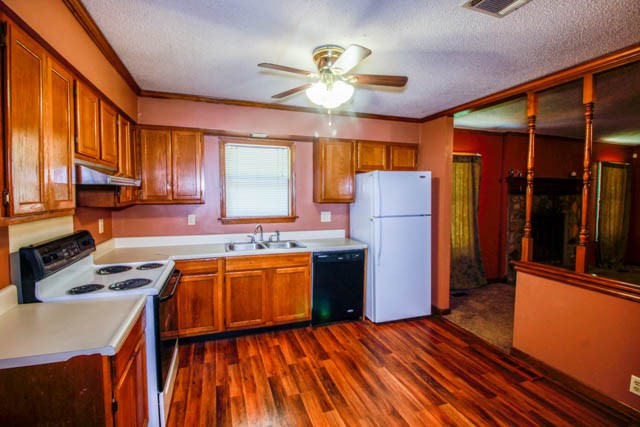 4 Broyles Road Phenix City, AL 36869 - Photo 6 of 15 a kitchen with stainless steel appliances granite countertop wooden floors a stove and a refrigerator