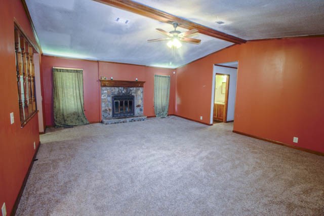 4 Broyles Road Phenix City, AL 36869 - Photo 9 of 15 a view of an empty room with a fireplace and chandelier fan