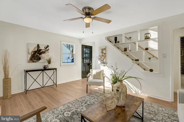 a living room with furniture a chandelier and a window