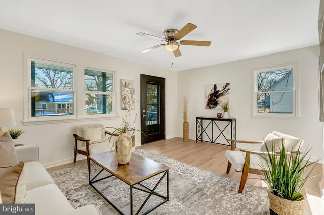 a kitchen with stainless steel appliances a white stove top oven a sink with wooden floors