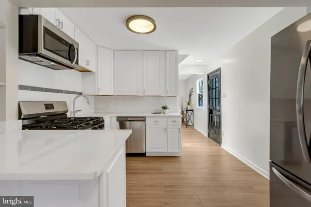 a spacious bathroom with a double vanity sink and a mirror