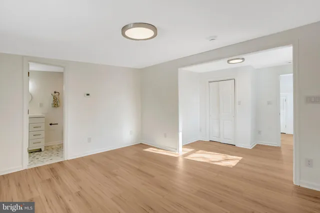 a bathroom with a sink a light fixture and a mirror