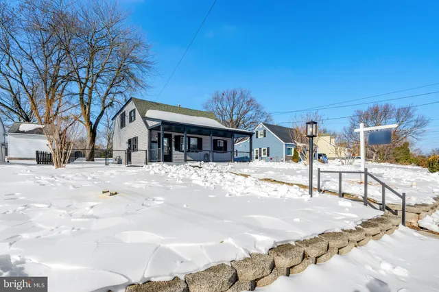 a view of house with outdoor space and covered with snow
