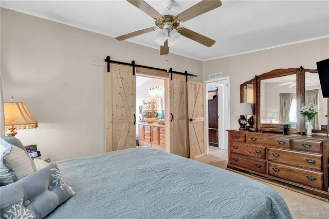 a bedroom with a large bed and a chandelier