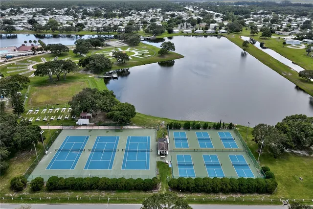 an aerial view of a house with a yard and lake view