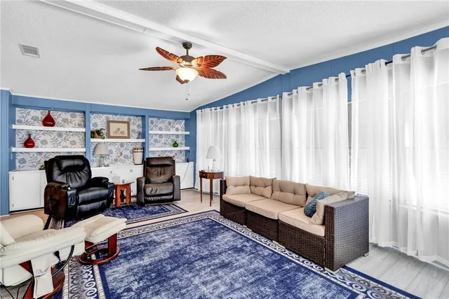 a living room with furniture a fireplace and a window