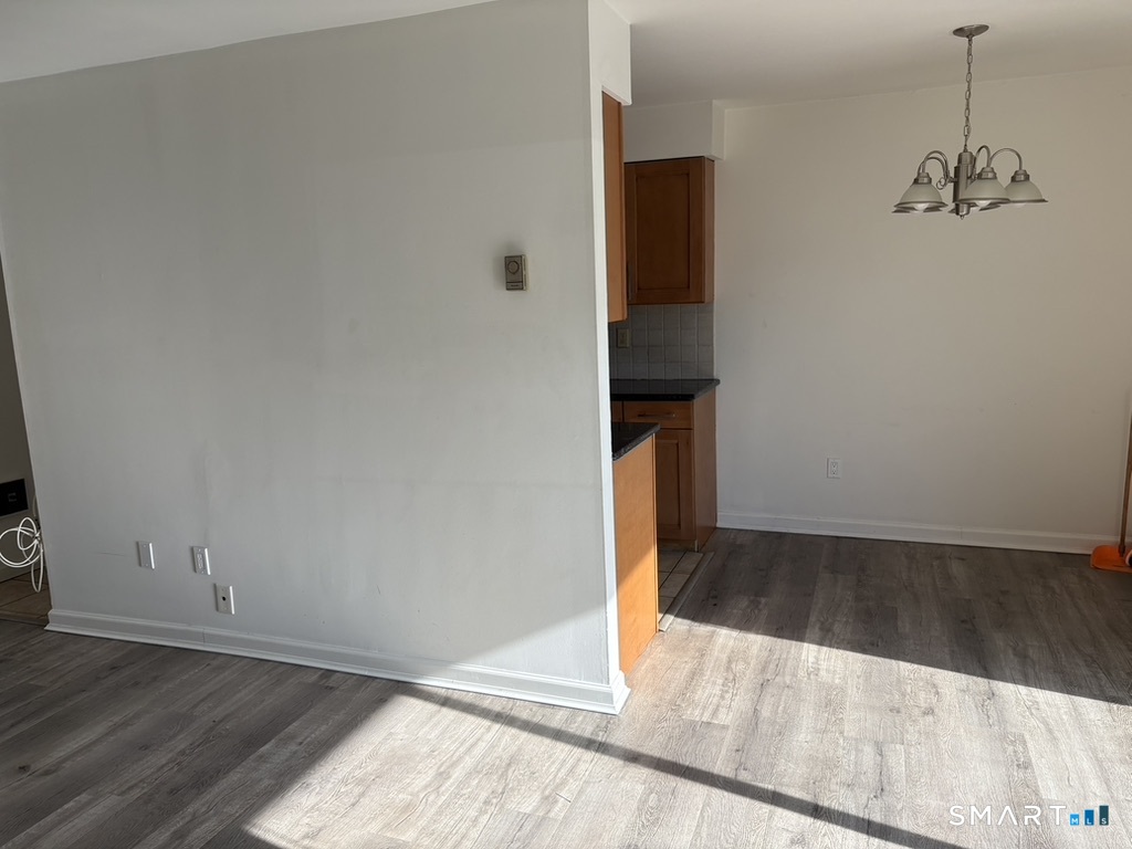 12 Tuttle Street, Unit 1C Stamford, CT 06902 - Photo 6 of 14 an empty room with wooden floor