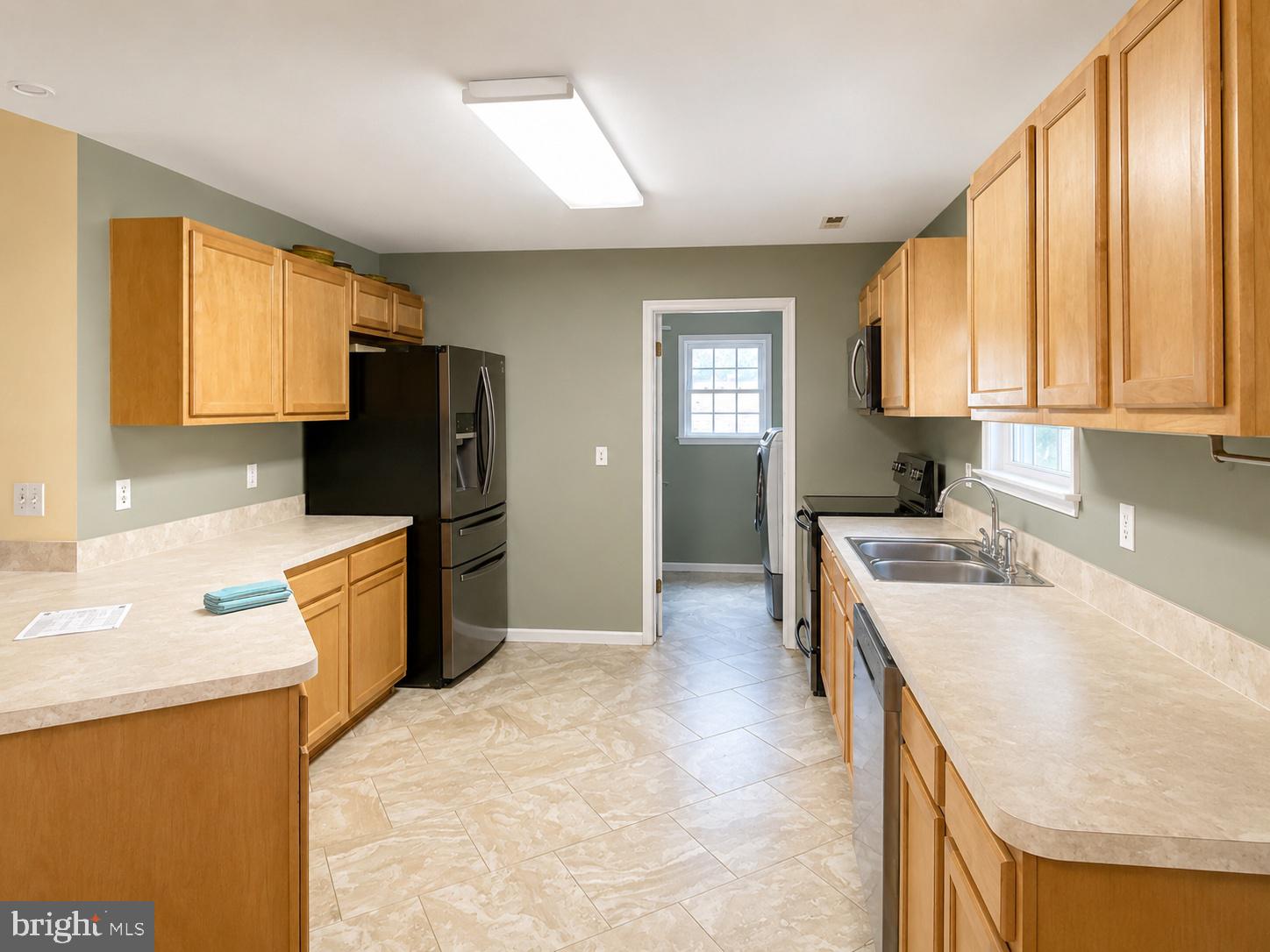 550 Walnut Shade Road Louisa, VA 23093 - Photo 3 of 7 a kitchen with a refrigerator a stove a sink dishwasher and wooden cabinets with wooden floor