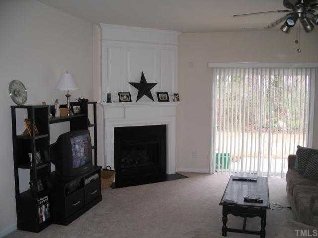 8159 Rhiannon Road Raleigh, NC 27613 - Photo 3 of 12 a living room with furniture and a fireplace
