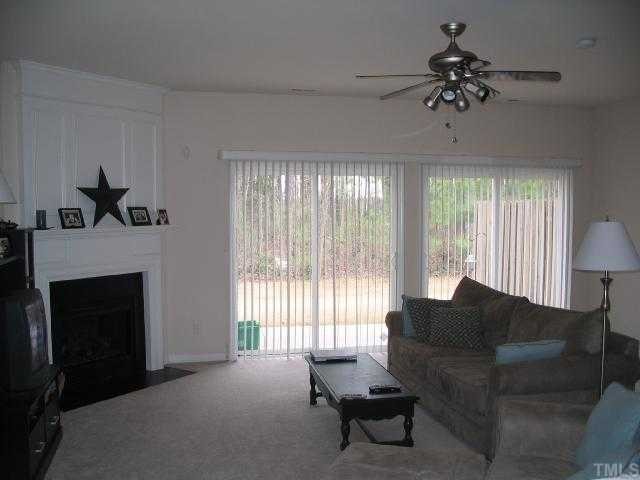 8159 Rhiannon Road Raleigh, NC 27613 - Photo 4 of 12 a living room with furniture and a fireplace