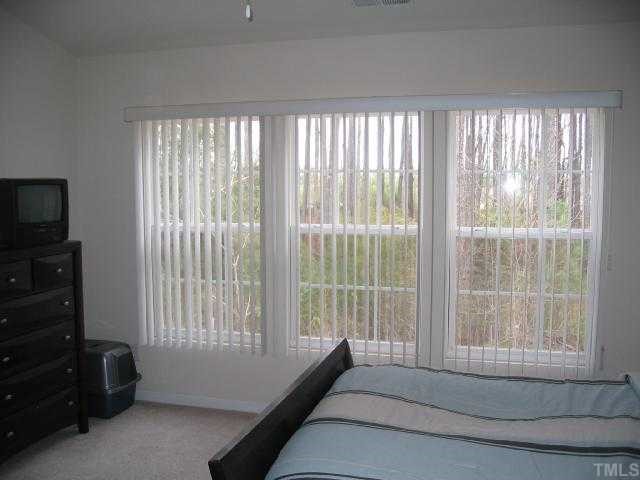 8159 Rhiannon Road Raleigh, NC 27613 - Photo 6 of 12 a bedroom with a bed and a television