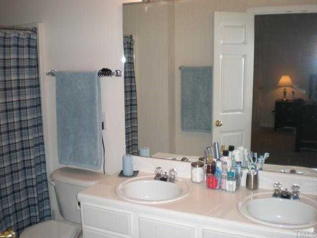 8159 Rhiannon Road Raleigh, NC 27613 - Photo 7 of 12 a bathroom with a sink and a mirror