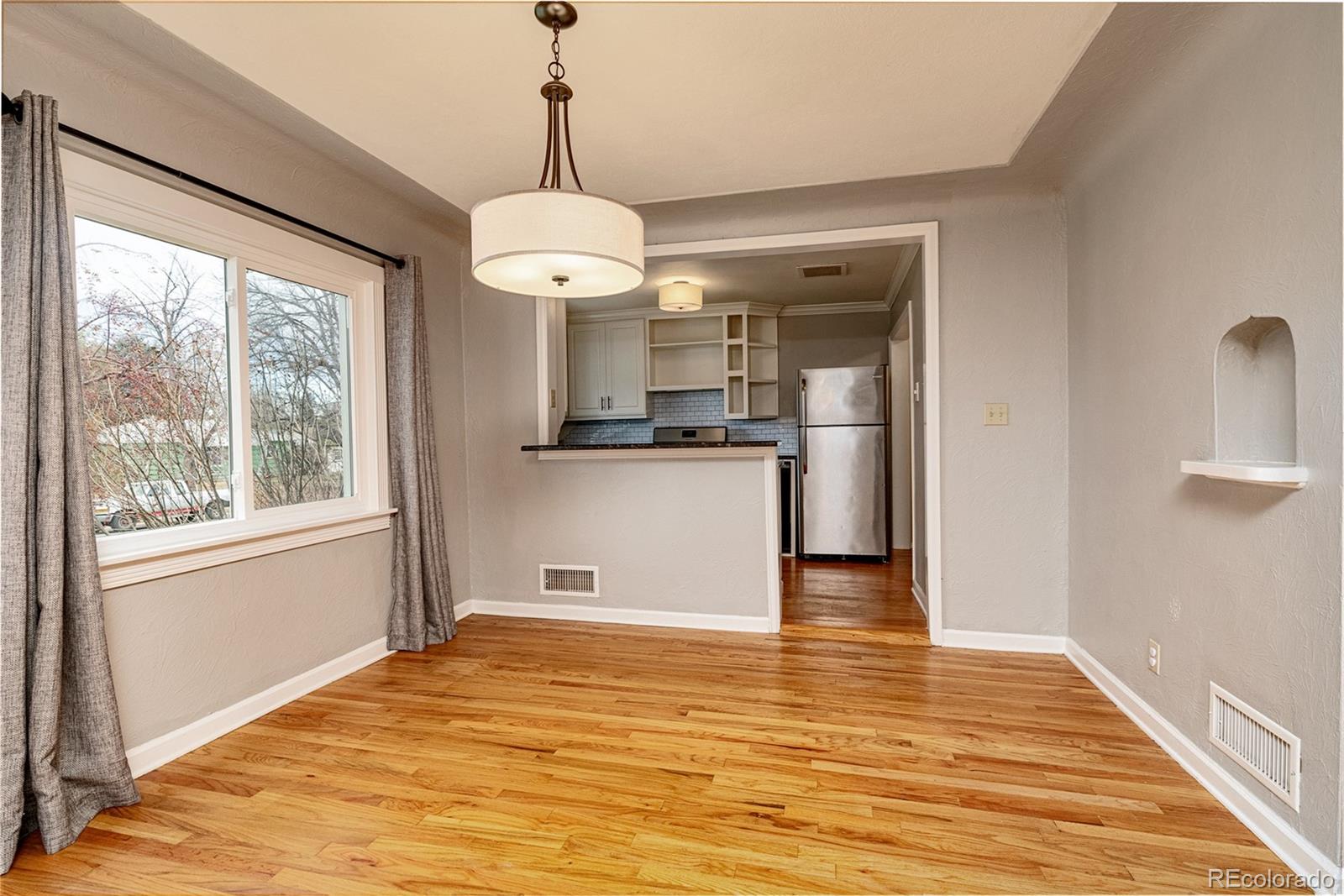 1250 Emporia Street Aurora, CO 80010 - Photo 11 of 33 a view of a kitchen with a stove wooden cabinets and wooden floor